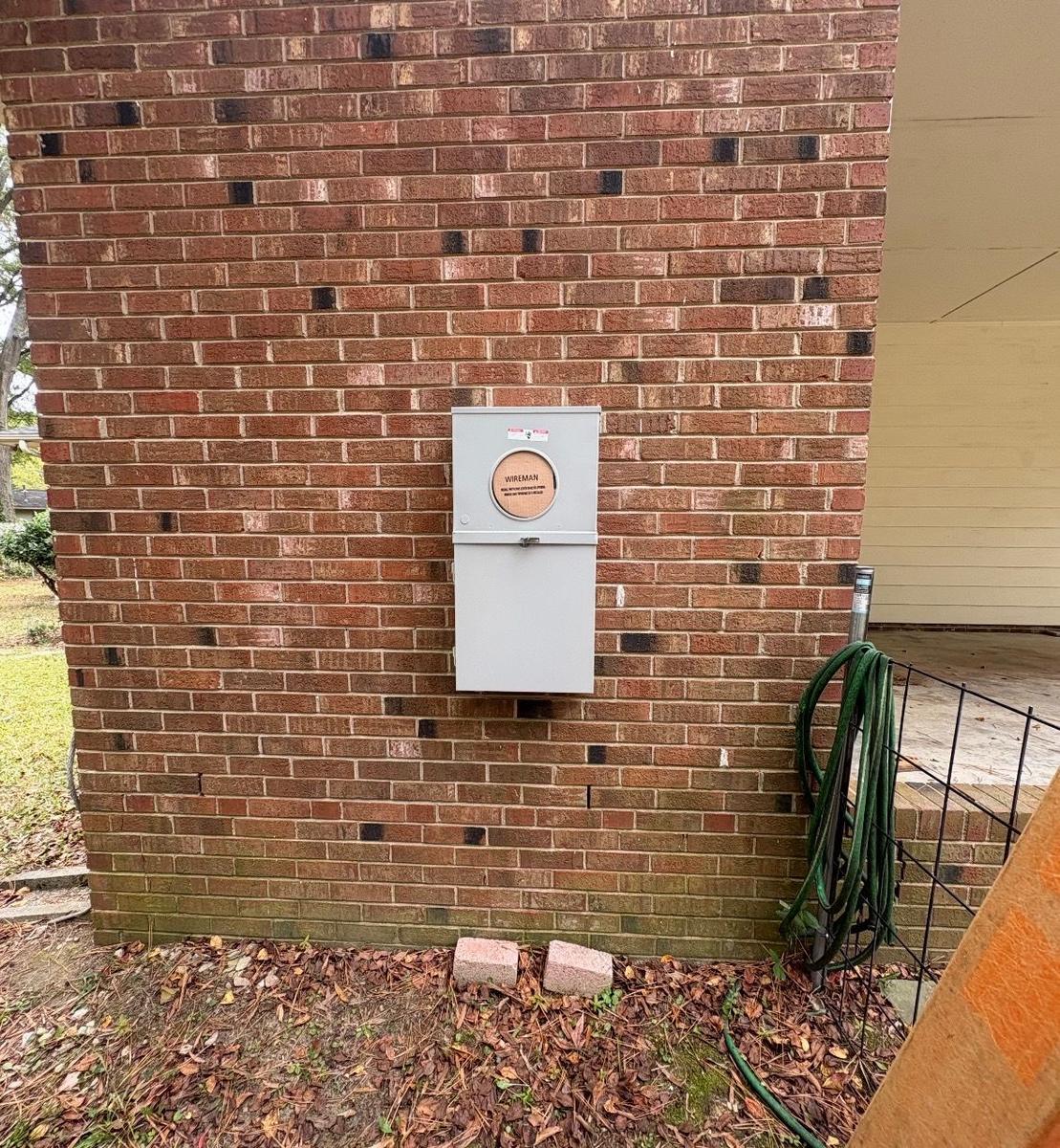 New 200-amp meter base with main breaker on a brick home