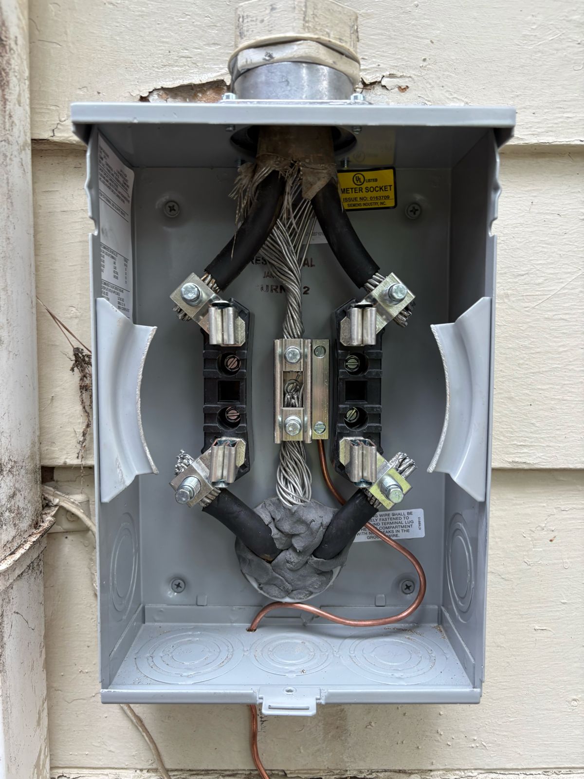 Inside a newly installed meter base with new jaws and bonding