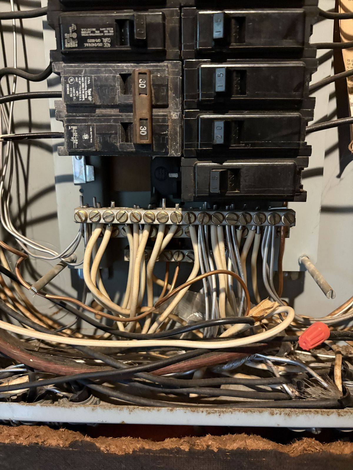 Close-up of the neutral bar and breakers in an old ITE panel
