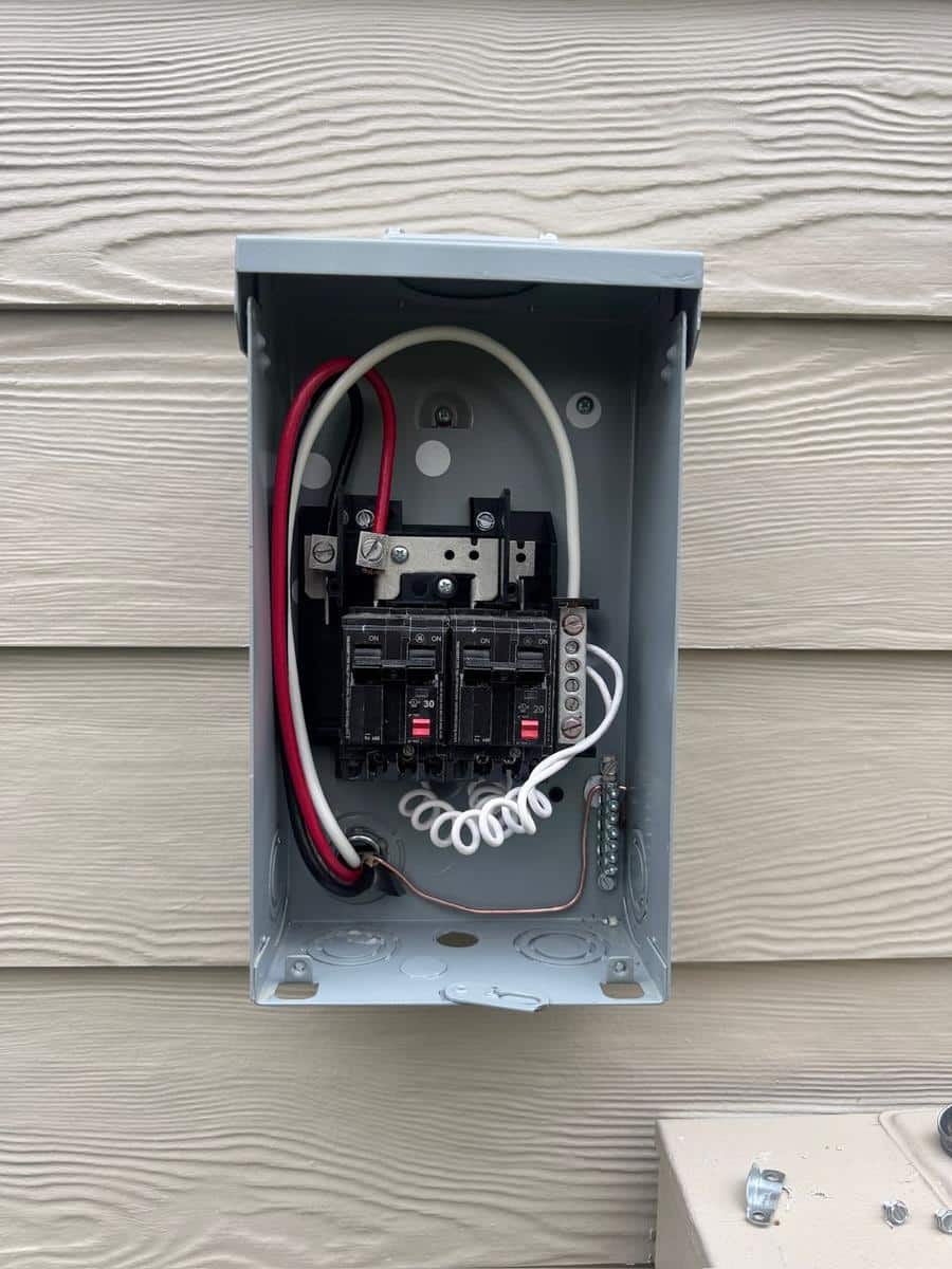 Small outdoor equipment panel with two 240-volt GFCI breakers