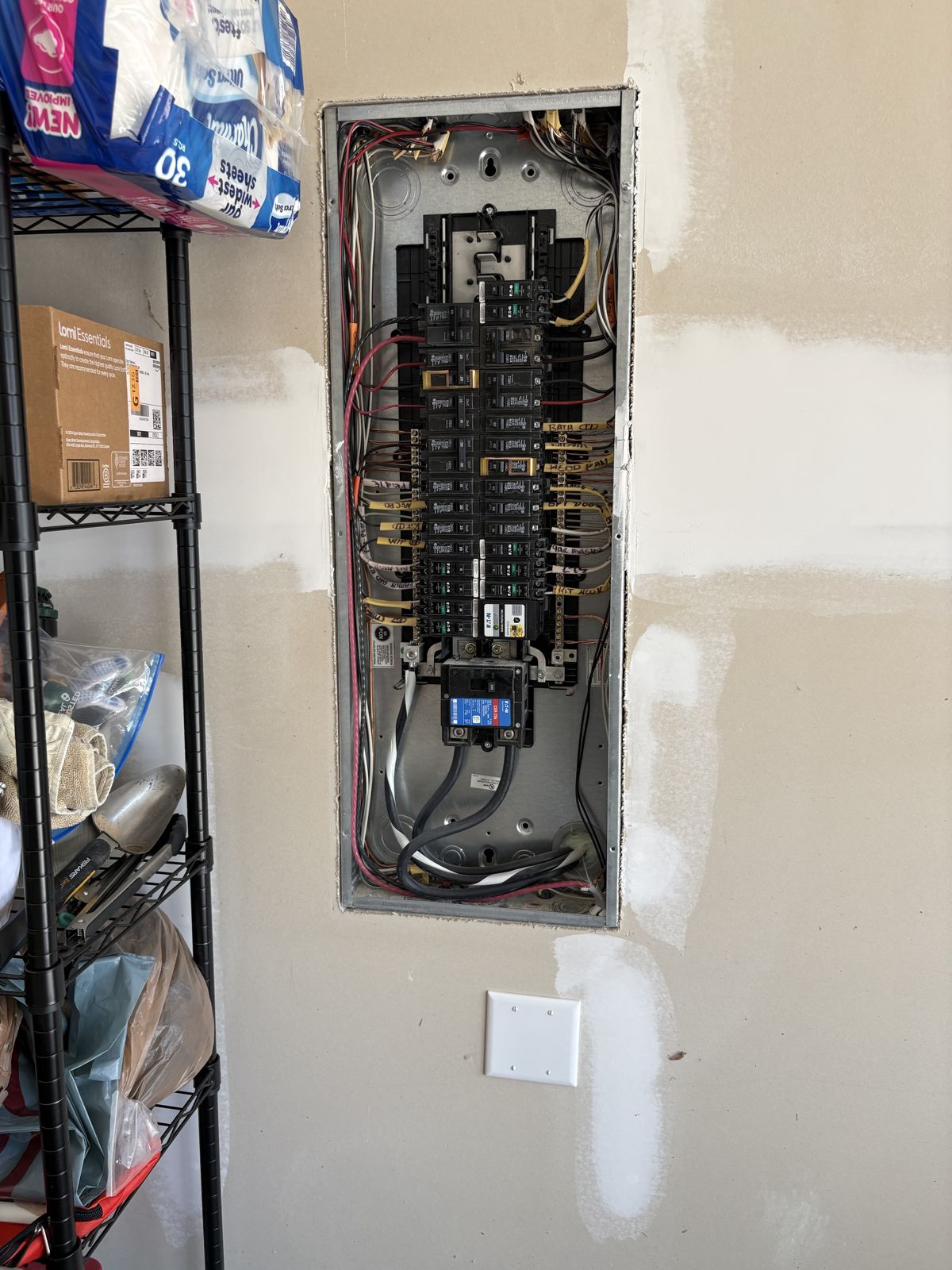 Open electrical panel with the new EV charger breaker installed