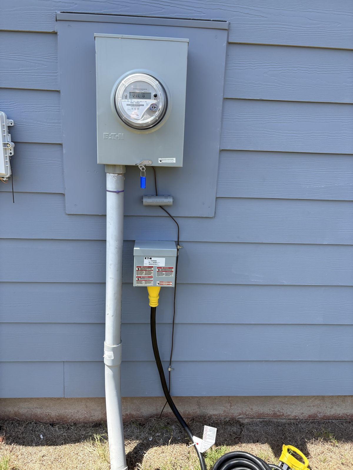 Finished 50-amp generator inlet below the meter with the generator cord connected
