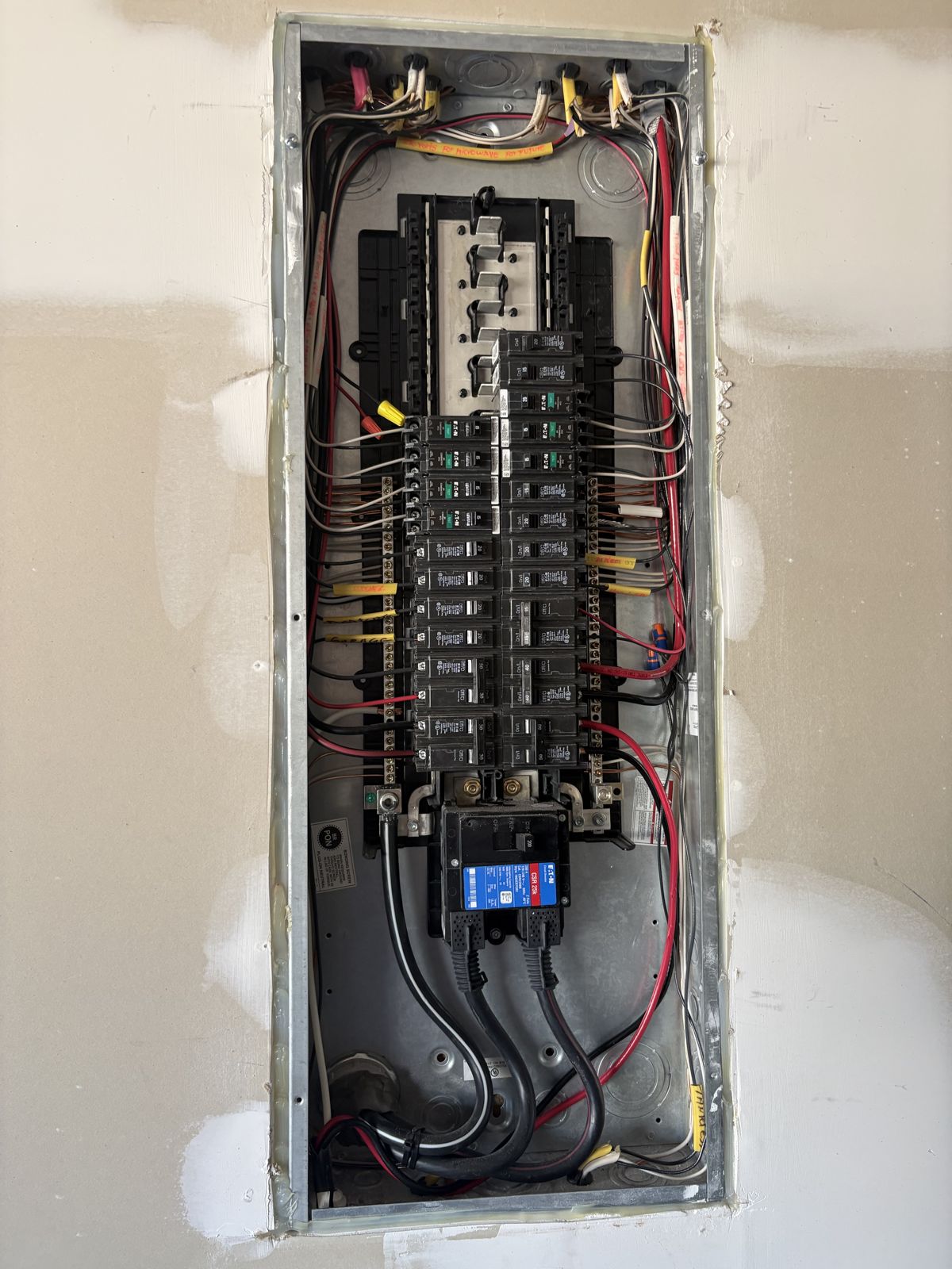 Open electrical panel during wiring of a 50-amp generator inlet circuit