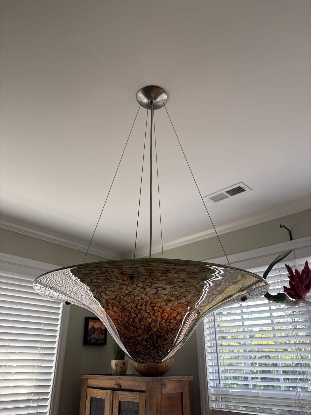 Custom art-glass chandelier installed over a dining room in Raleigh, NC