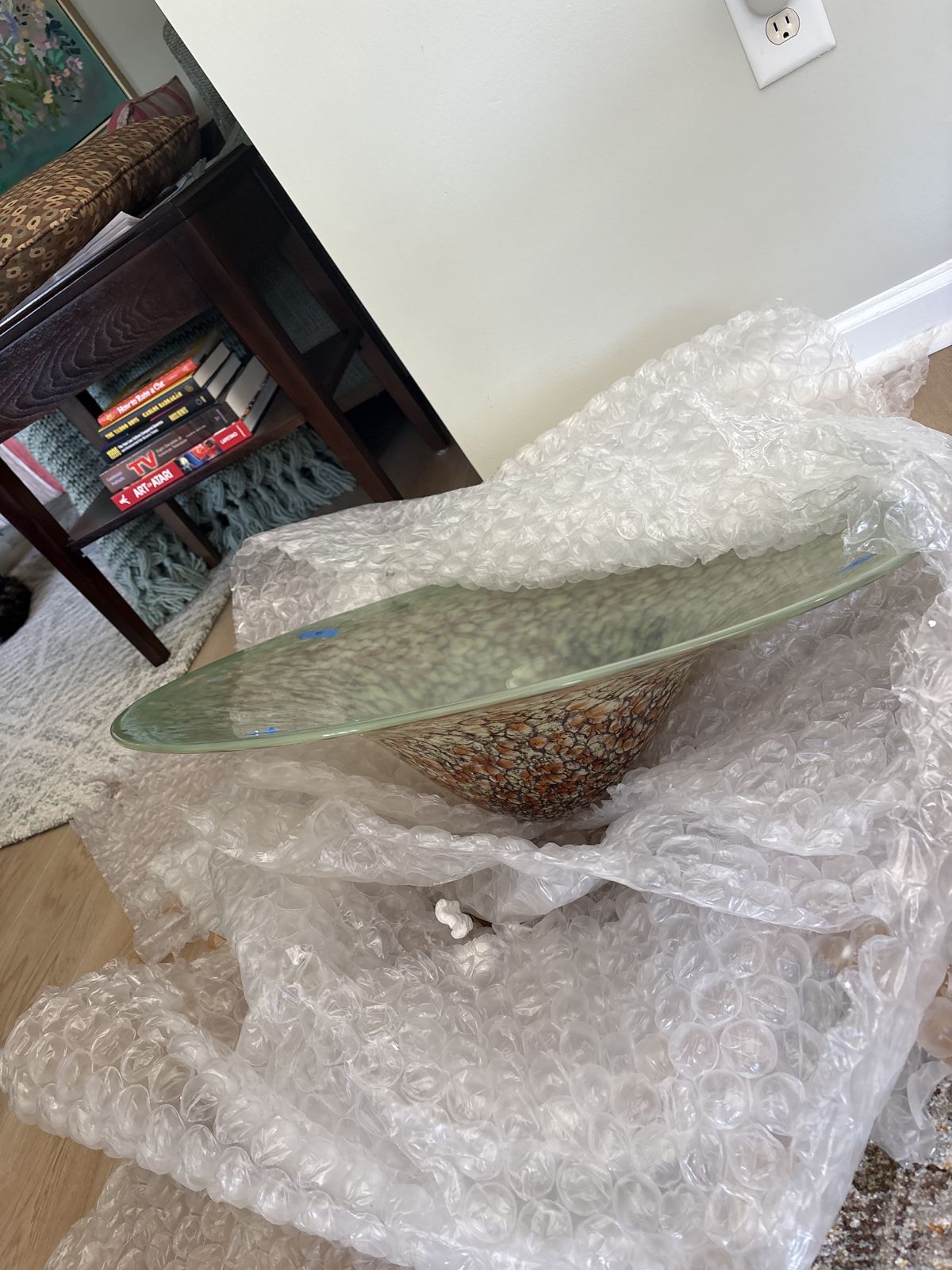 Custom colored art-glass chandelier shade being unpacked before installation