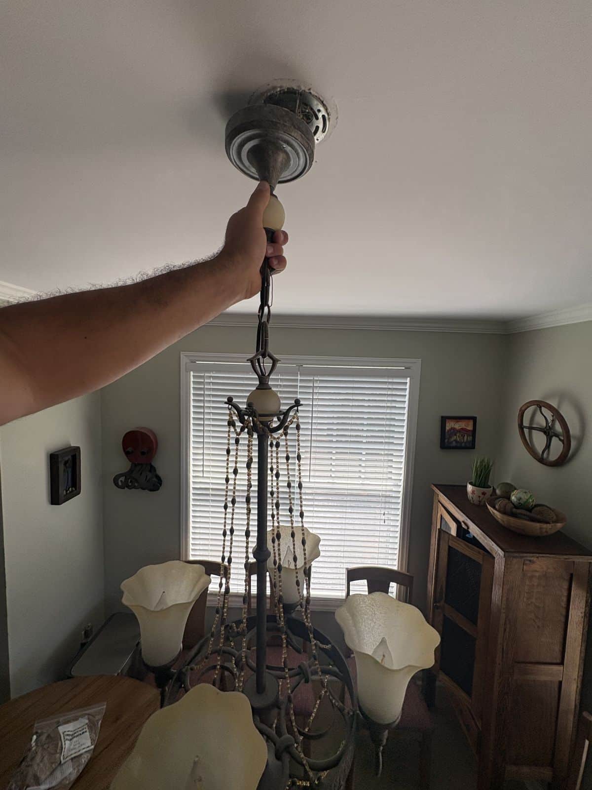 Old dining room chandelier before replacement in a 2004 home in Raleigh, NC