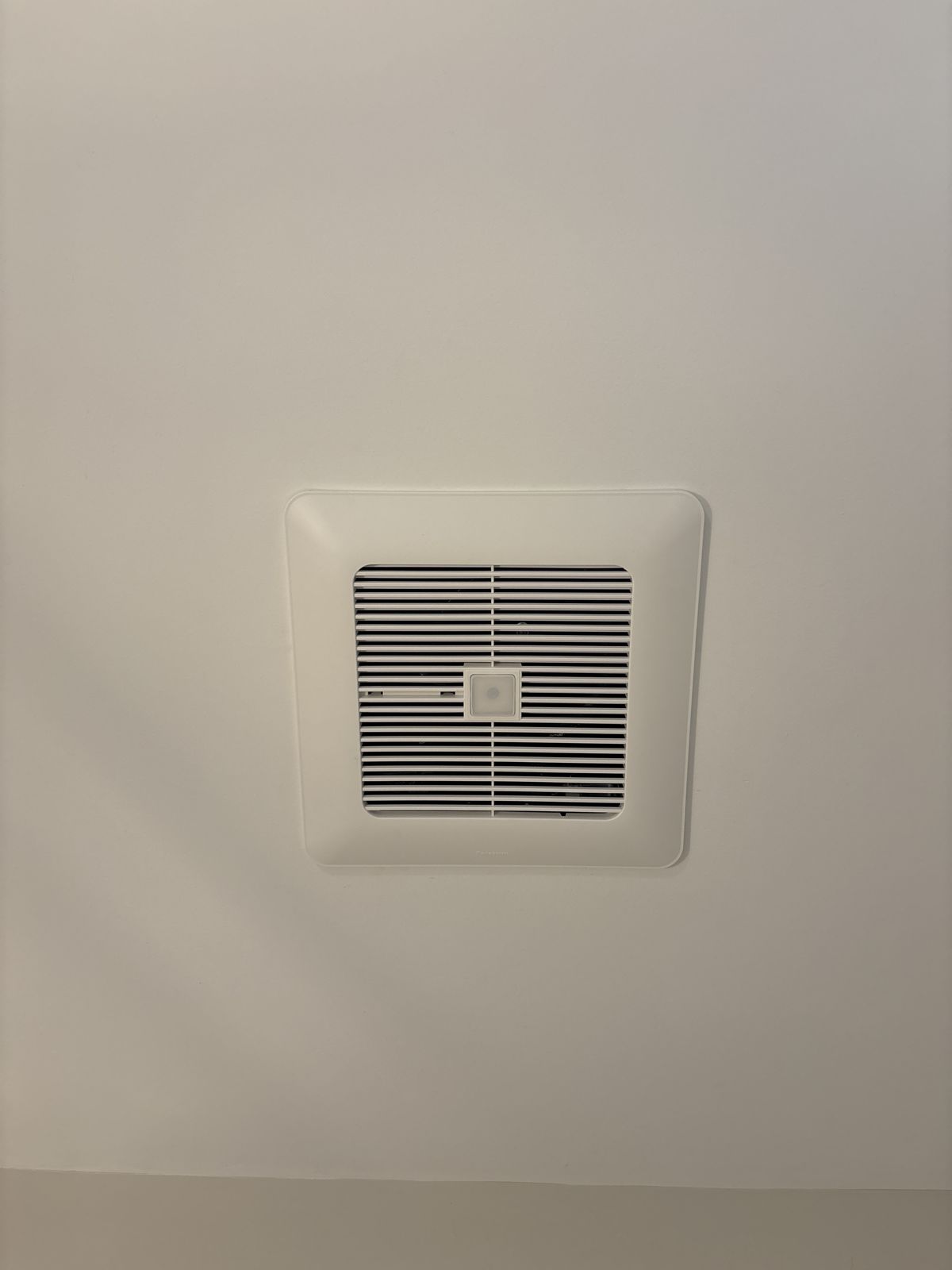 Humidity-sensing bathroom exhaust fan installed in a bathroom ceiling