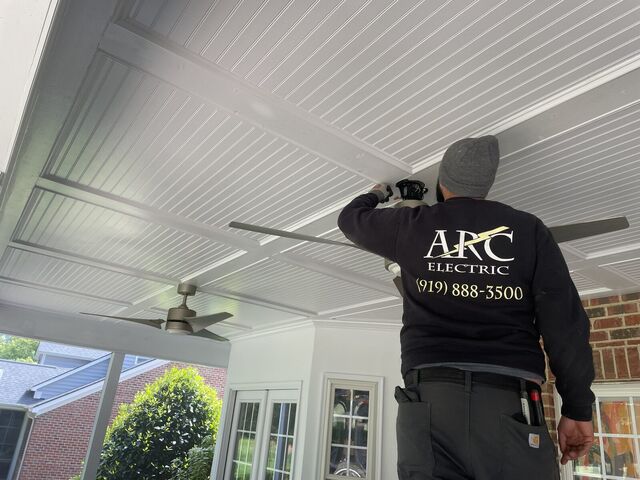 ARC electrician installing a porch ceiling fan