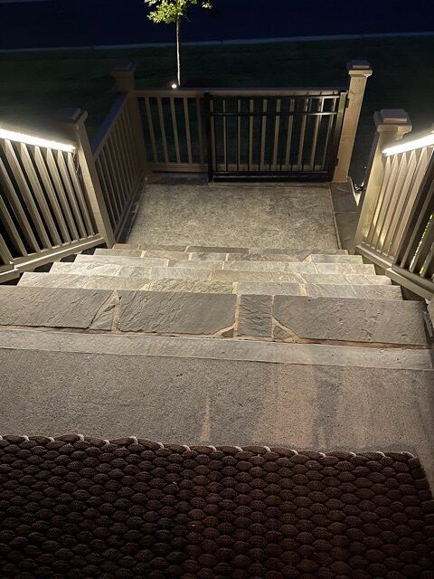 Step lights on a deck staircase and stone landing
