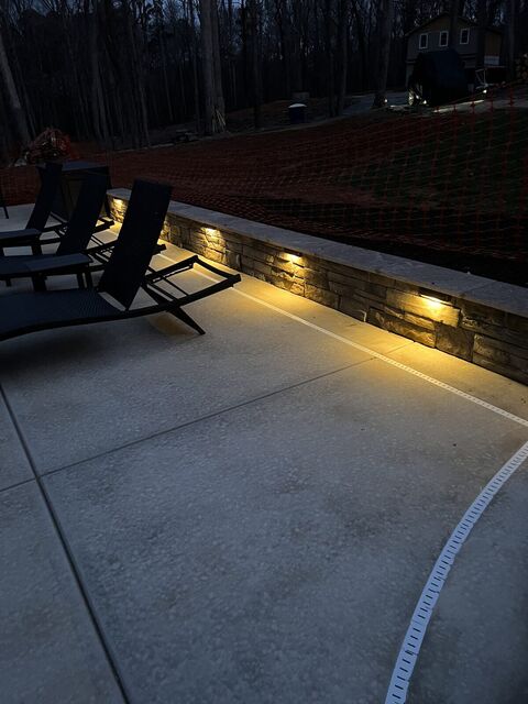 Hardscape lights set into a stone patio wall
