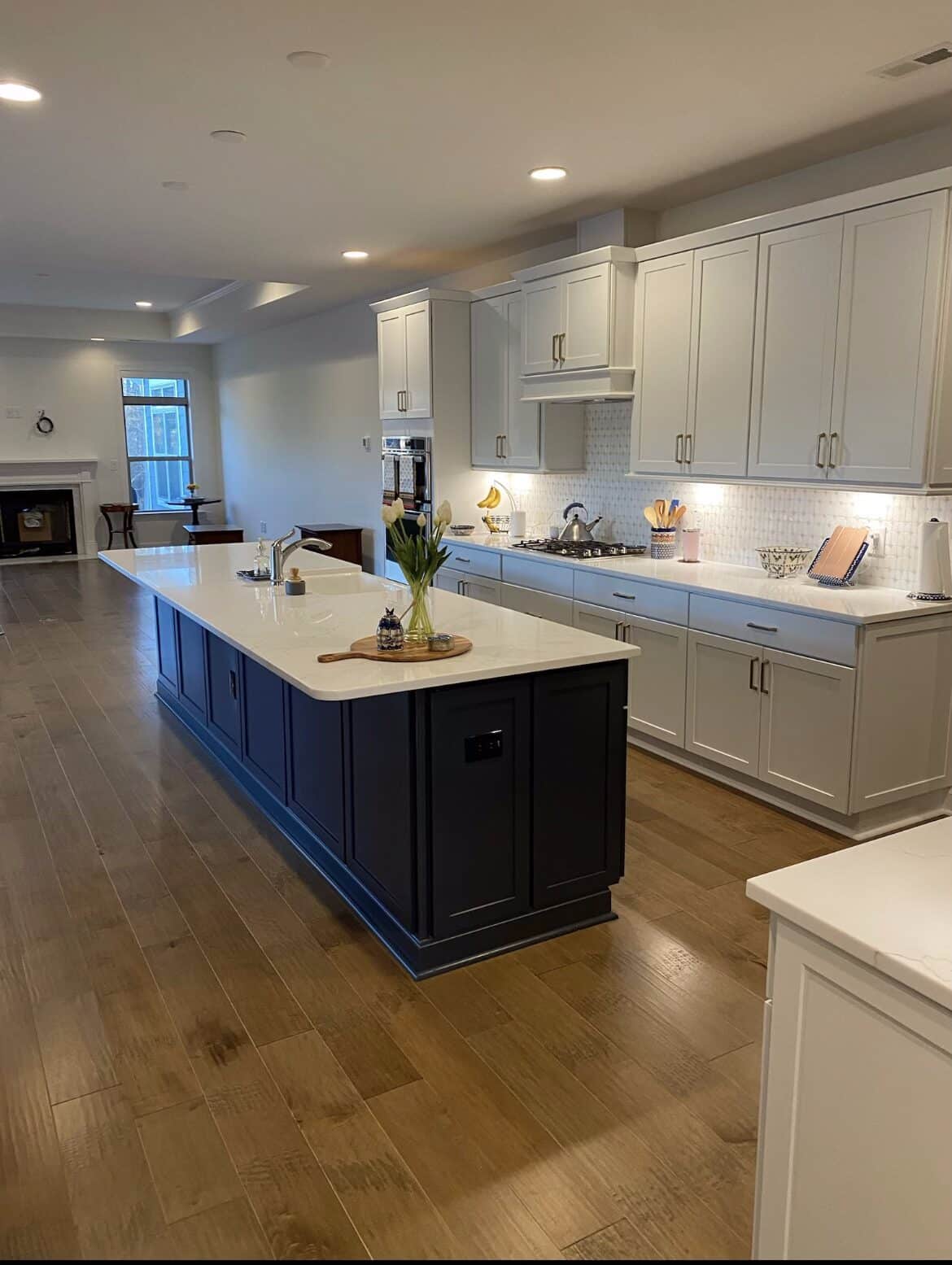 Recessed LED lighting and island pendants in an open kitchen