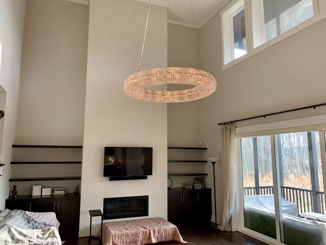 Large ring crystal pendant in a two-story living room