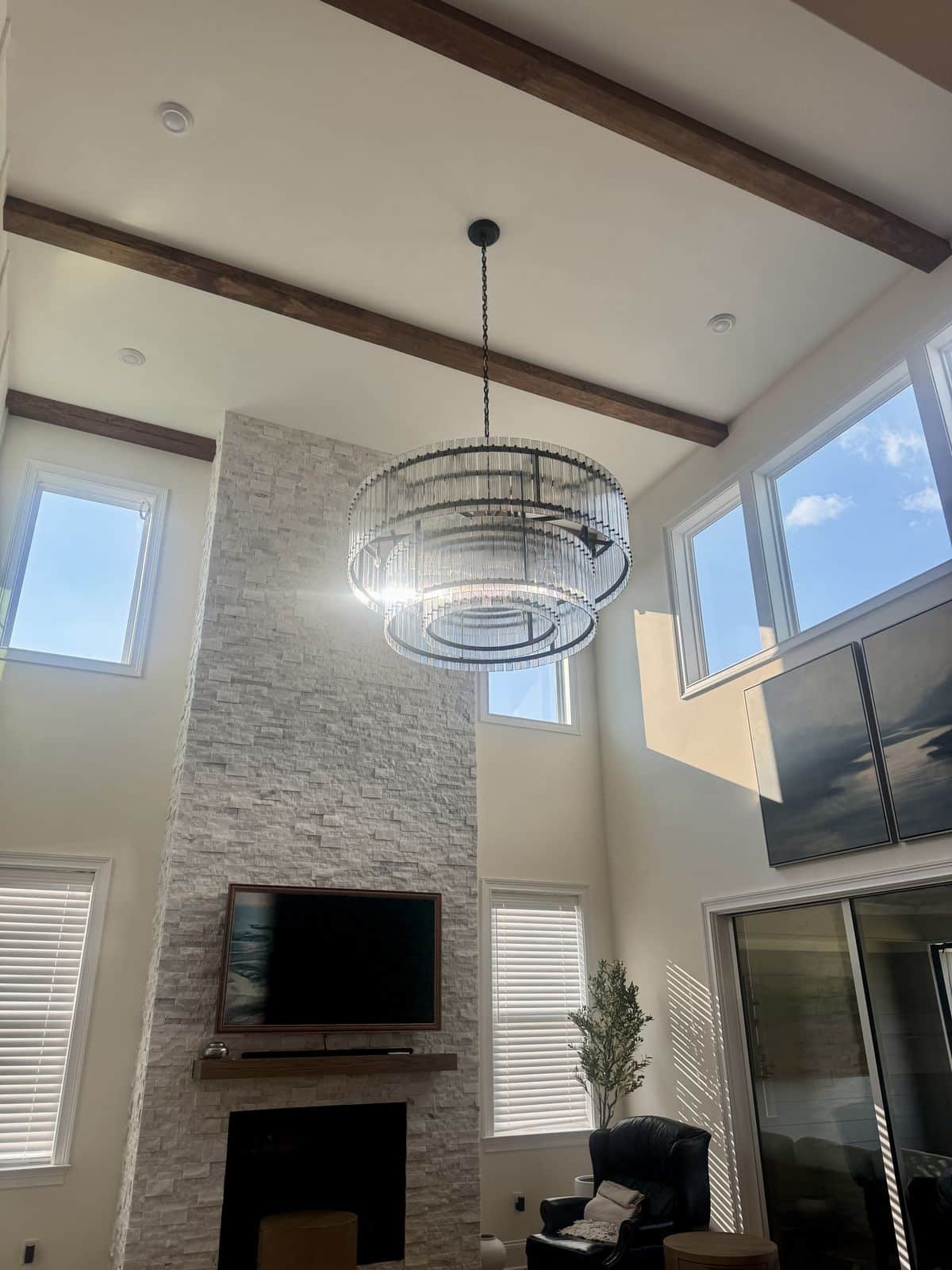 Two-tier crystal chandelier installed on a 24-foot living room ceiling in Fuquay-Varina, NC