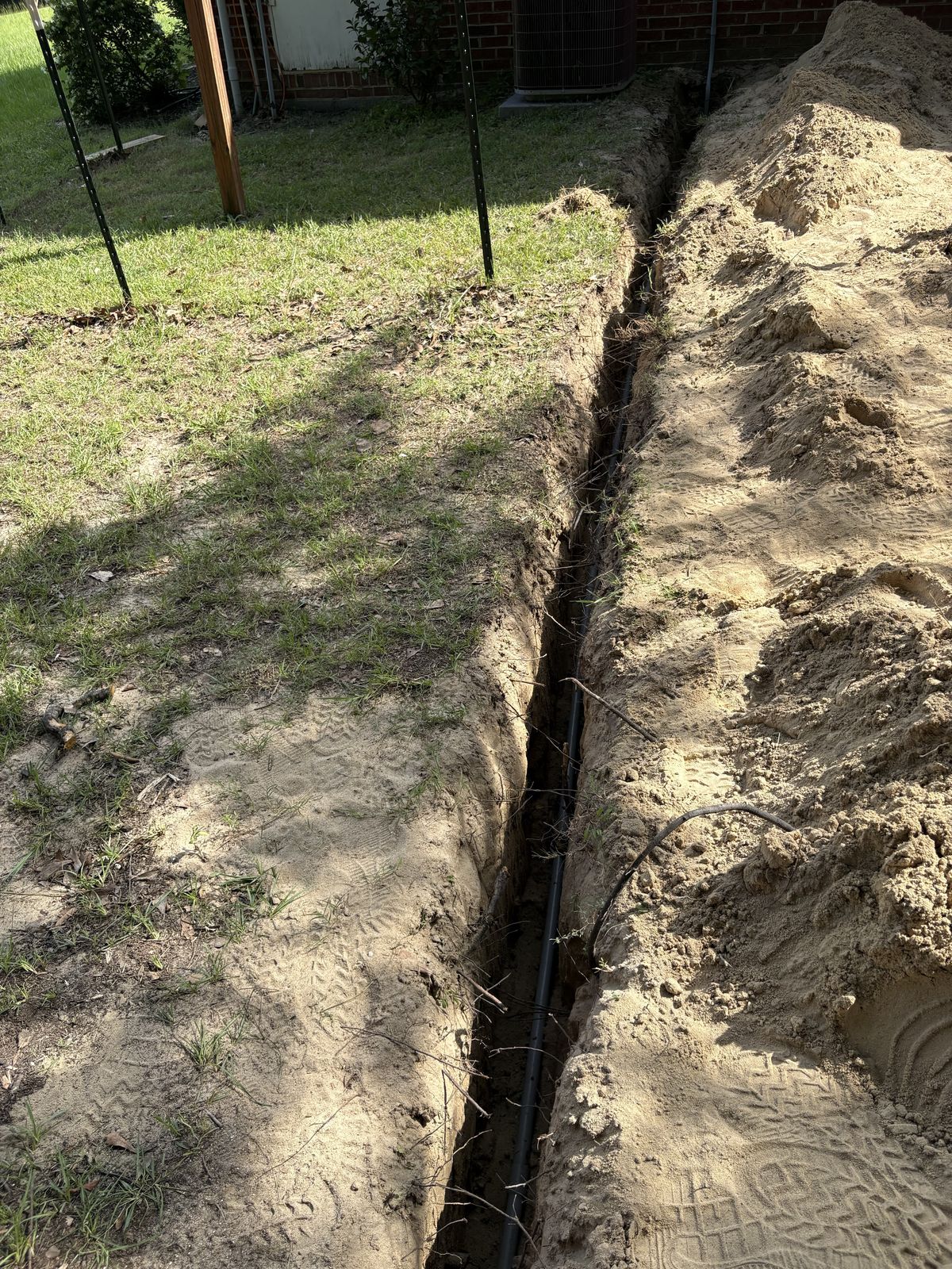 Trench dug across a yard for the underground circuit to a second shed in Fuquay-Varina, NC